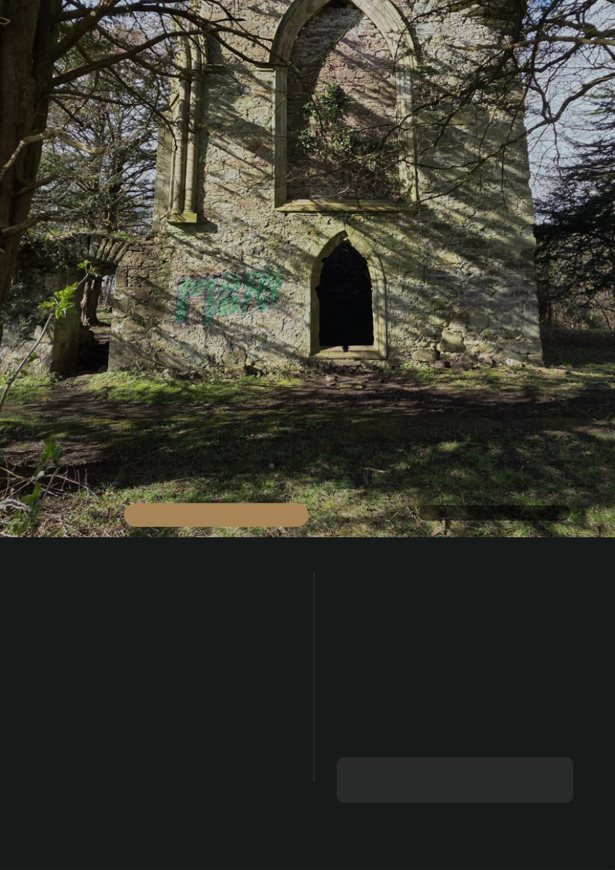 A small stone ruin surrounded by woodland